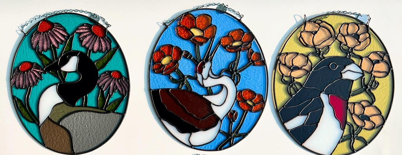 Set of six oval stained glass pieces with various birds and floral designs on a white background.