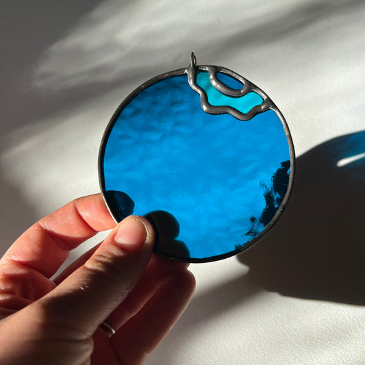 hand holding a textured stained glass blueberry